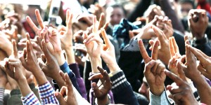 Protesters' hands in victory sign.